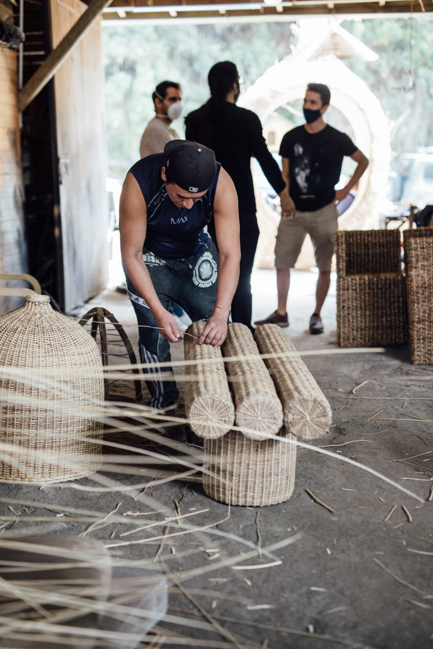 Photograph of a local artisan weaving yaré to produce a bench in the workshop.