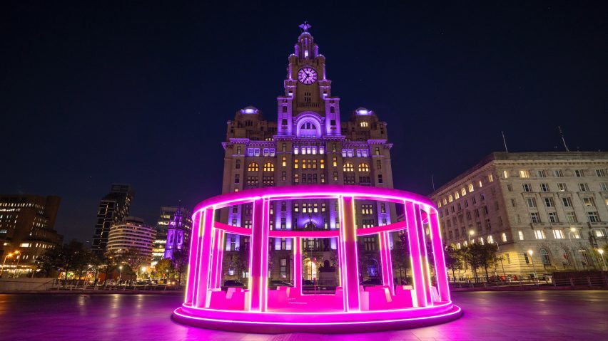 Photograph of a bright pink amphitheatre-like lighting installation.