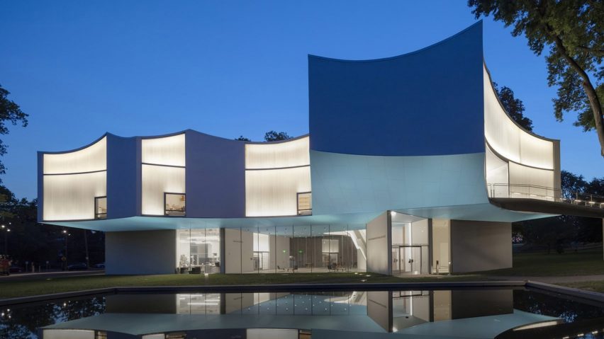 Photograph of a building with interesting geometric architecture that has been emphasised through lighting design.