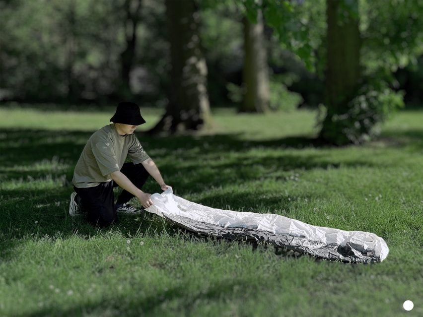 Man unfurling an inflatable hiking toilet