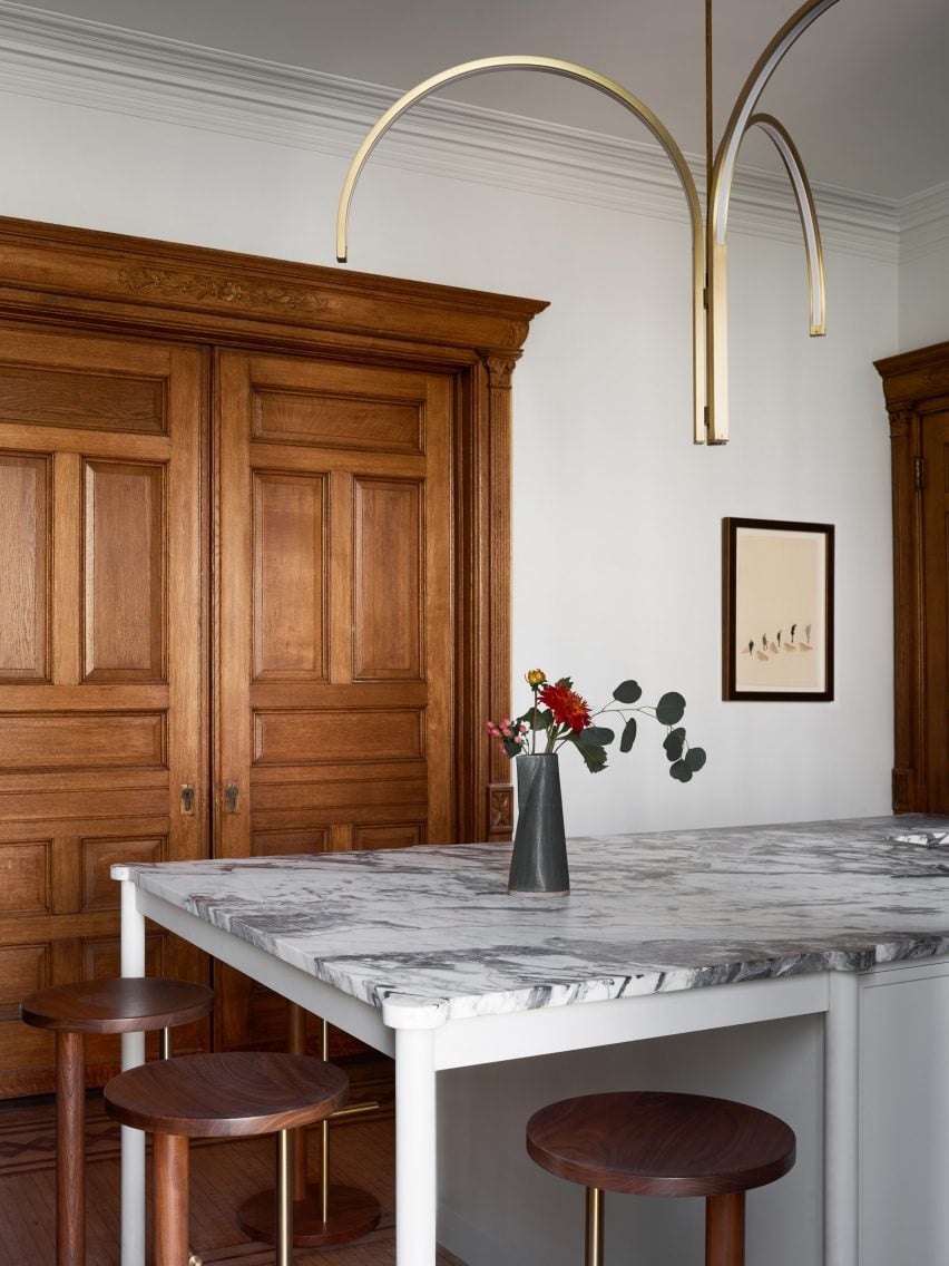 Kitchen of a Brooklyn townhouse with a dramatic brass chandelier