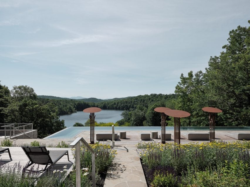 Swimming pool with seating areas between flower beds