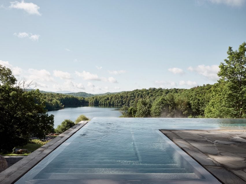 Infinity pool overlooking a lake and forest