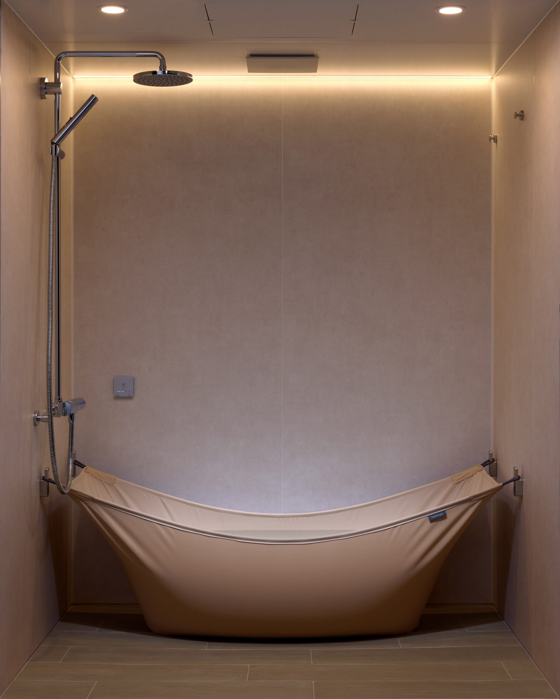 Bathtope by LIXIL mounted to a shower room wall