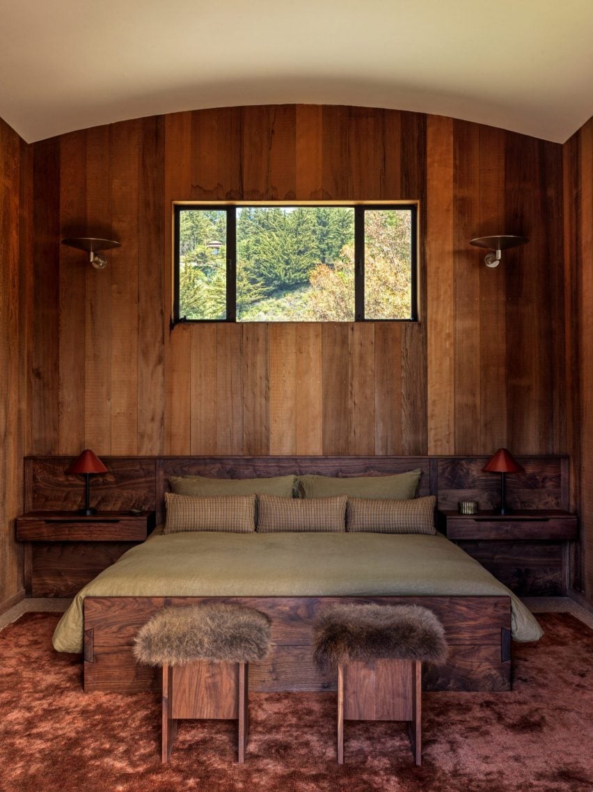 Bedroom with dark wood panelling and fluffy stools