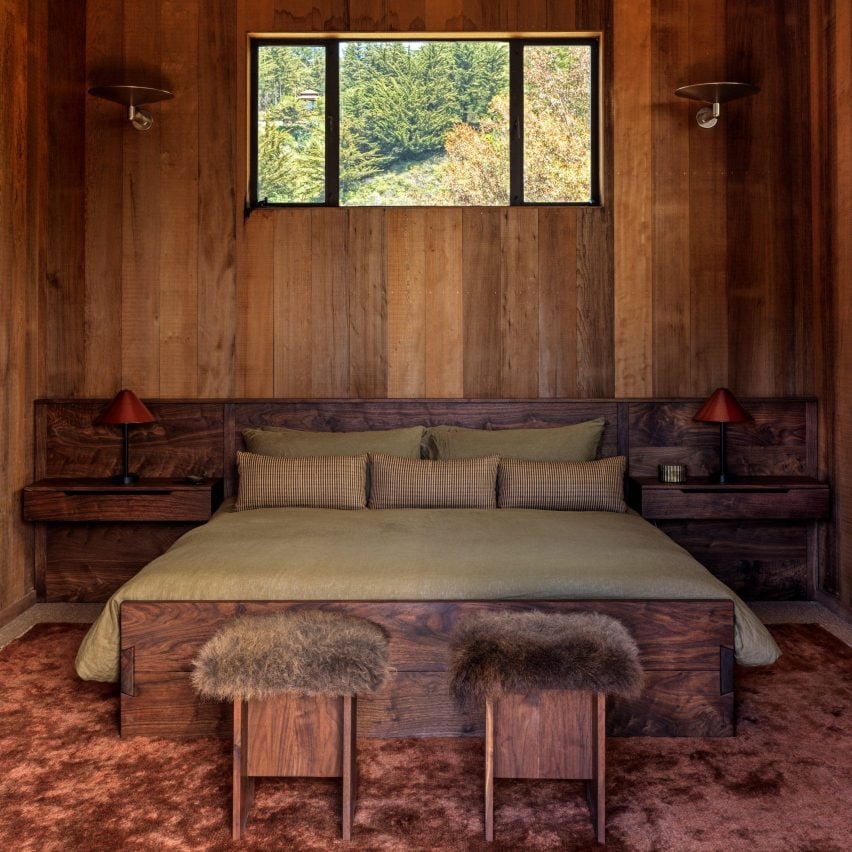 Wood lined bedroom with green bedsheets