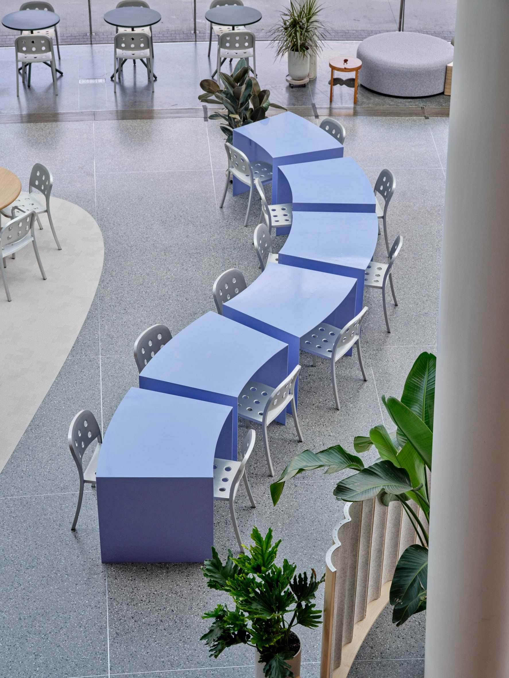 Row of periwinkle-hued tables with angled sides