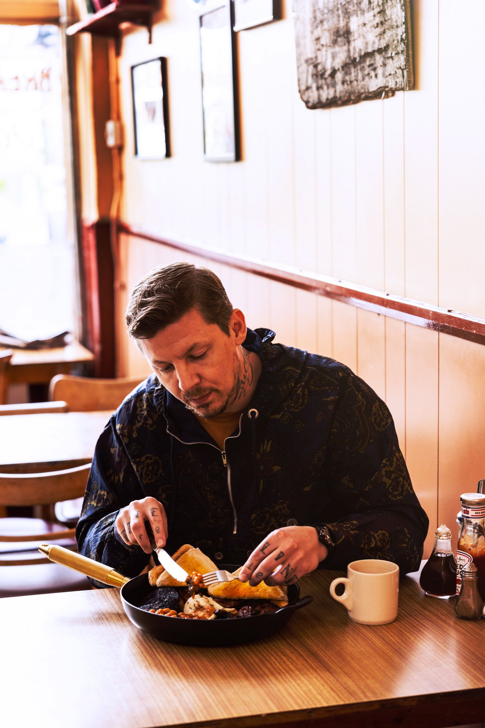 Professor Green eating in a cafe