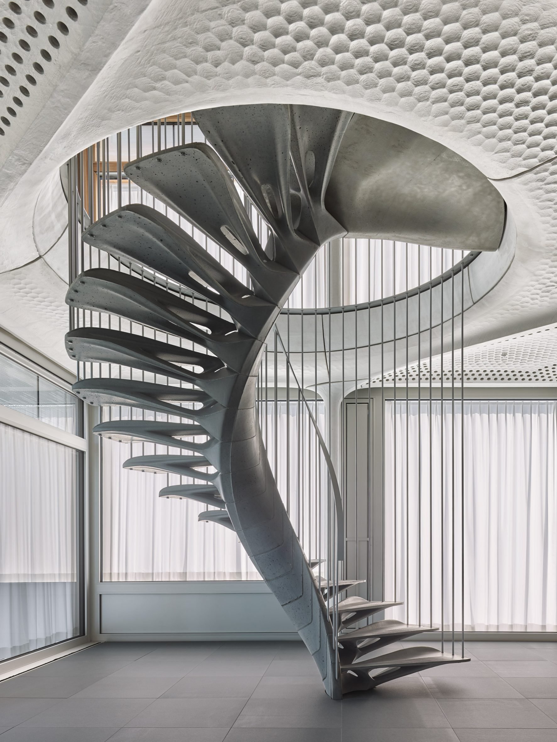 Photo of the Cadenza concrete staircase spiralling between two floors of the STEP2 Unit at the Nest building