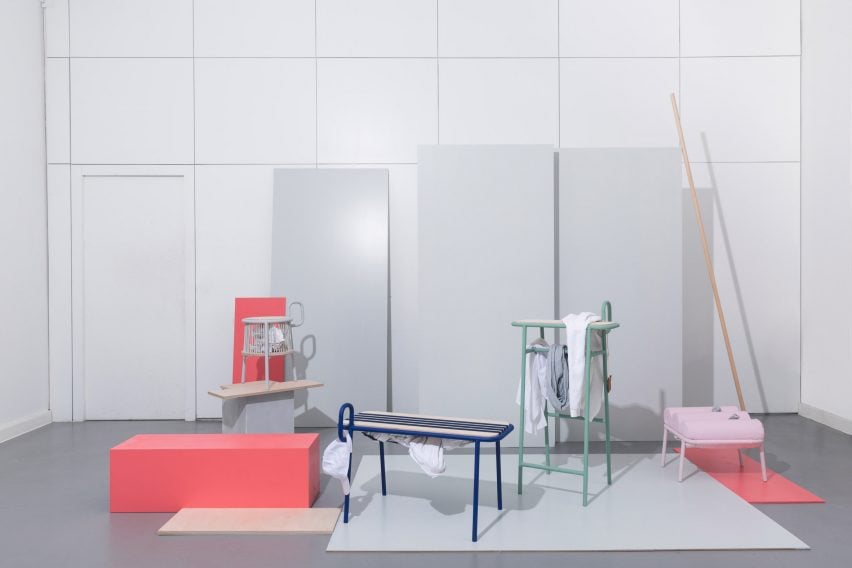 A photograph of a furniture collection in tones of pink, blue and green, against a backdrop of a grey room.