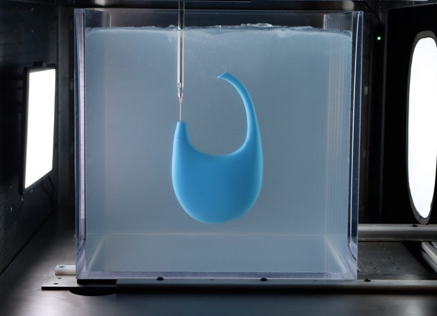 A photograph of a blue bag being 3D-printed in clear gel.