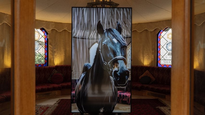 Tent doorway with horse on screen inside