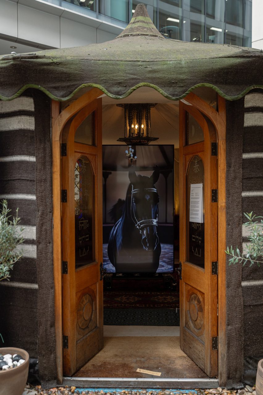 Tent doorway with horse on screen inside