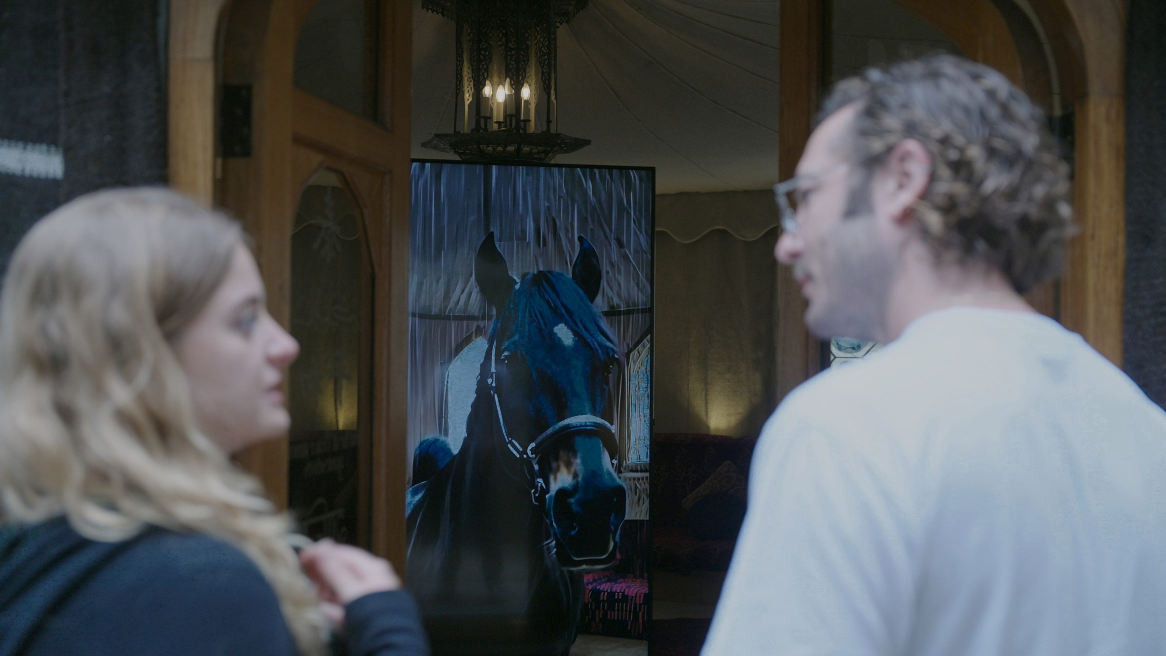 Tent doorway with horse on screen inside