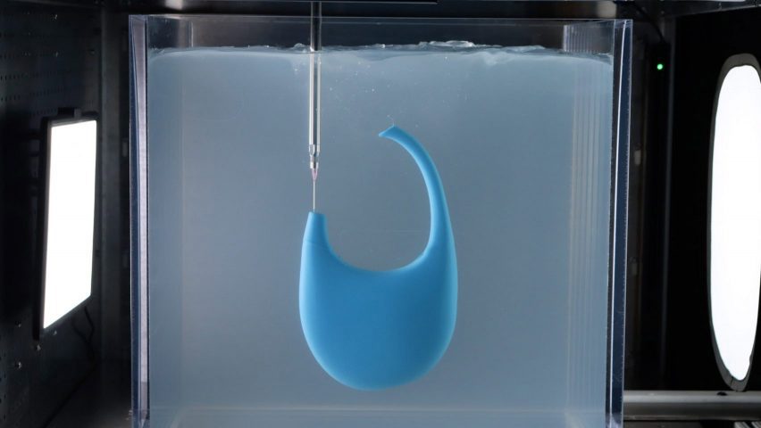 A photograph of a blue Coperni bag being rapid liquid 3D-printed