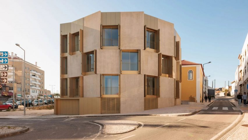 Portuguese housing block on roundabout with gold shutters