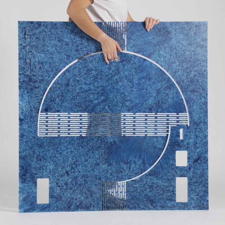 A photograph of a person handling an interactive table design in tones of blue.