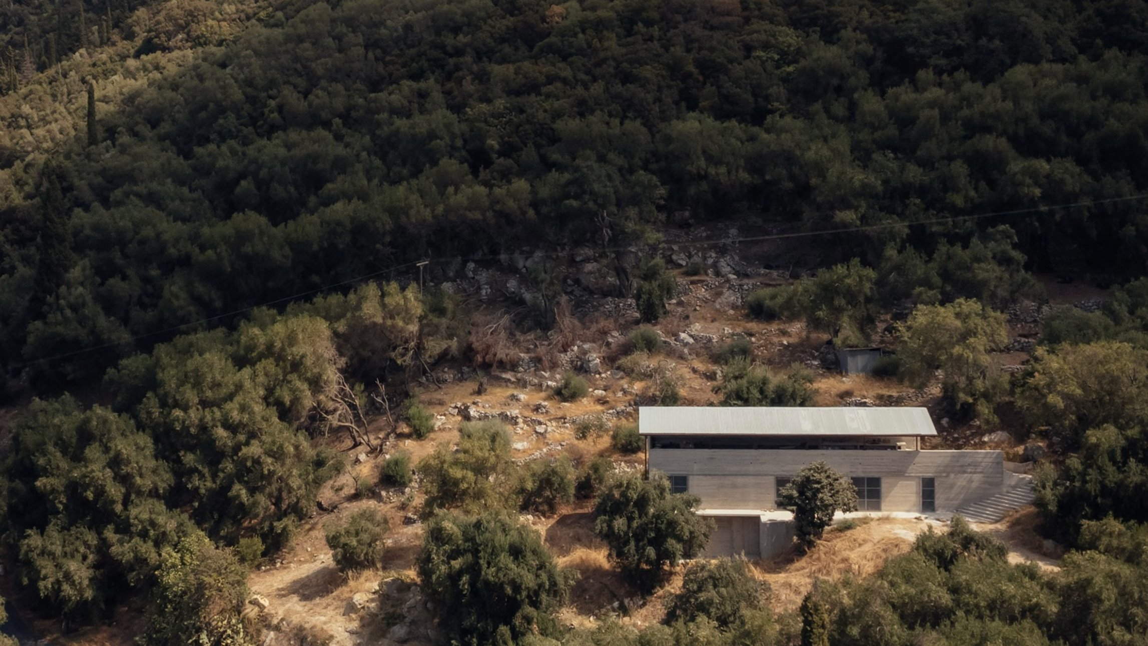 https://static.dezeen.com/uploads/2024/10/invisible-studio-house-in-an-olive-grove-greece_dezeen_2364_hero.jpg