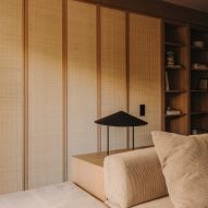 Rattan concertina doors closing off bedroom from living room