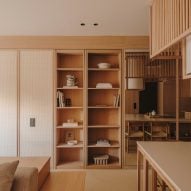 Wood bookcase concealing doorway in apartment