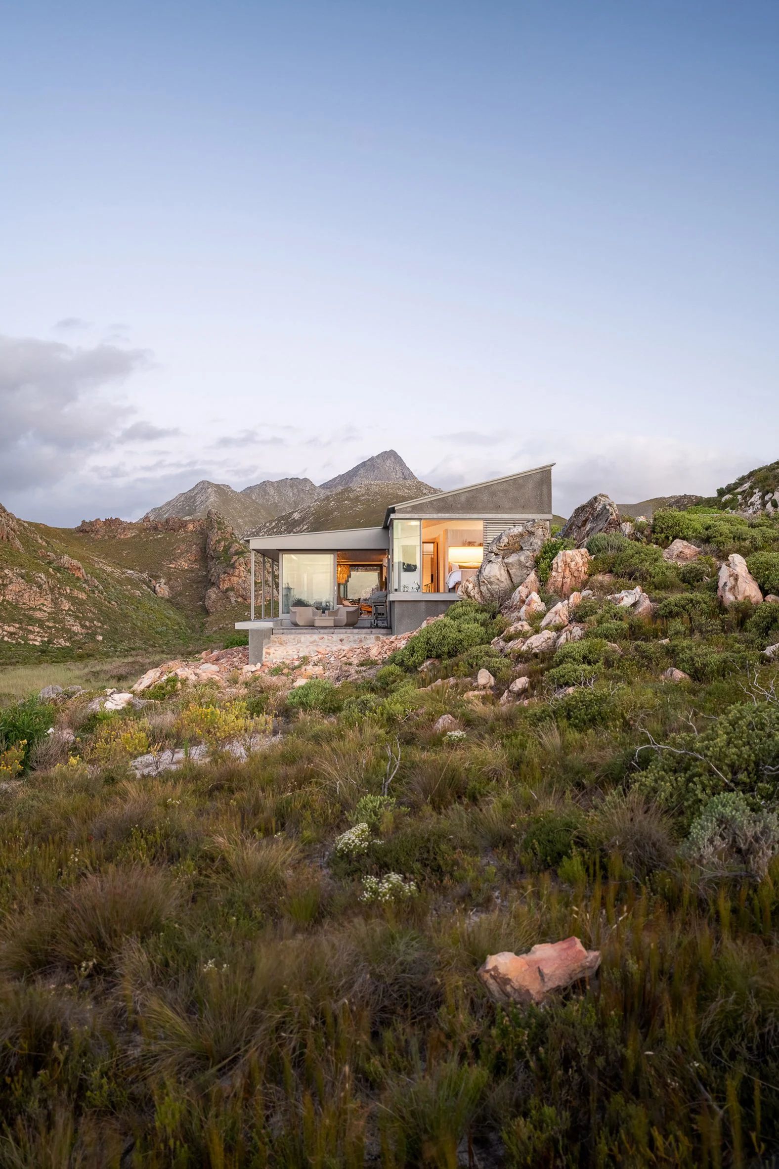 House nestled into mountain landscape