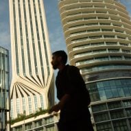 Man walking past Mercury Tower