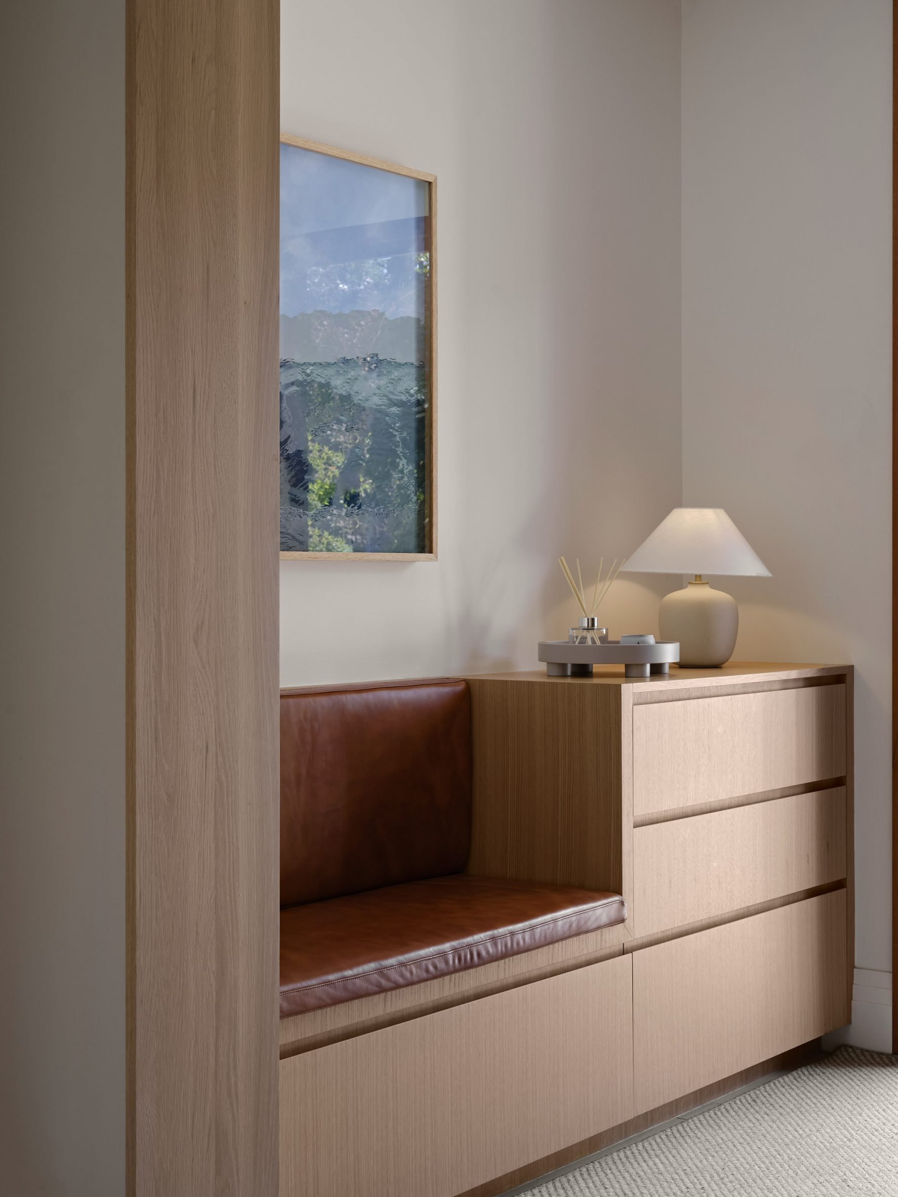 Built-in seat and storage made from white oak with brown leather cushions