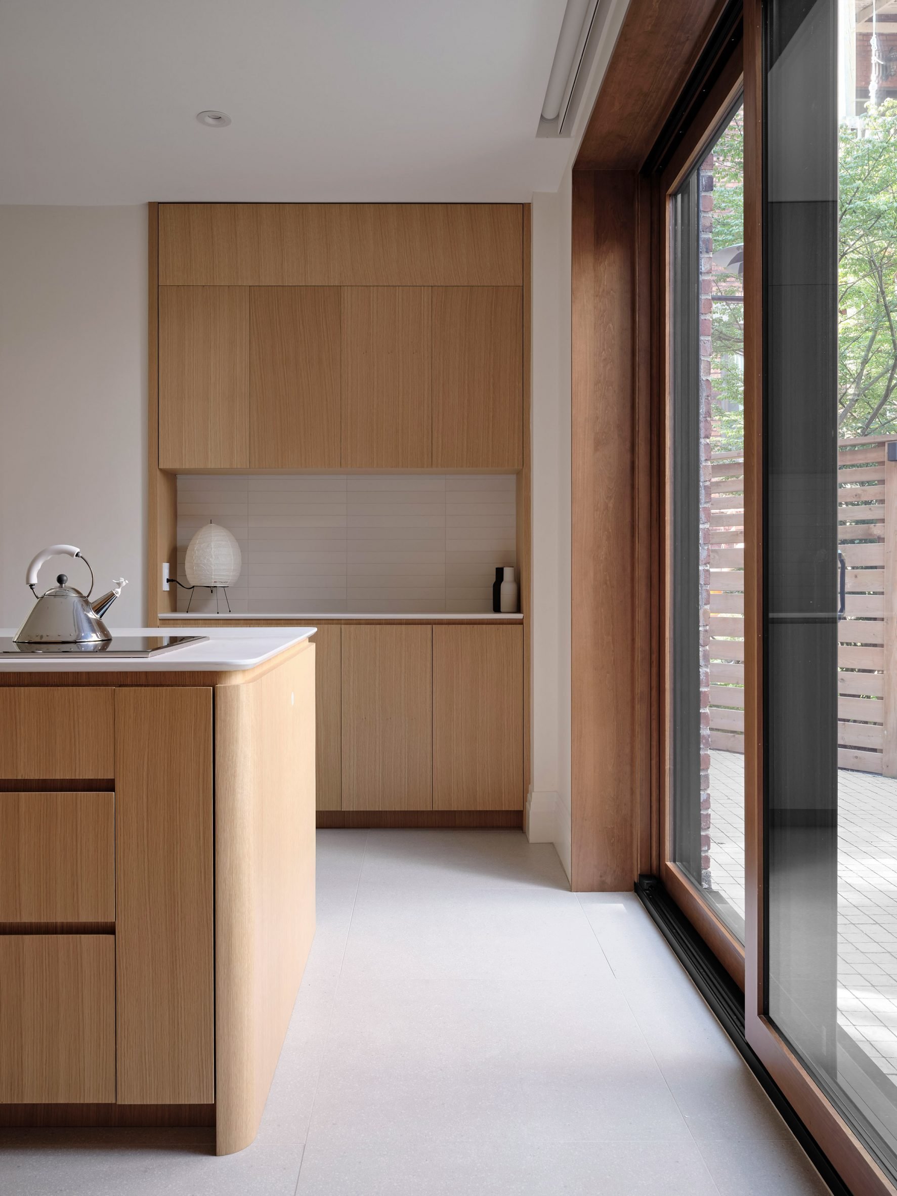 Kitchen with island on the left and sliding glass doors on the right