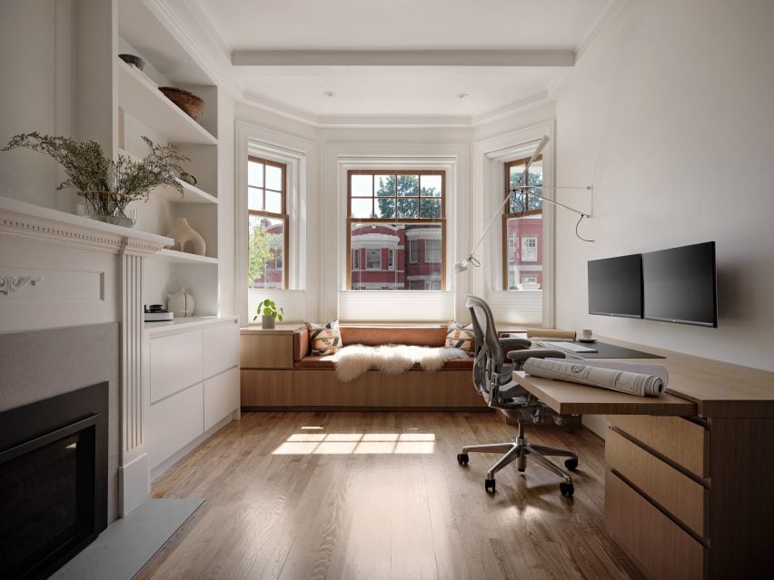 Home office with a seat built under a bay window