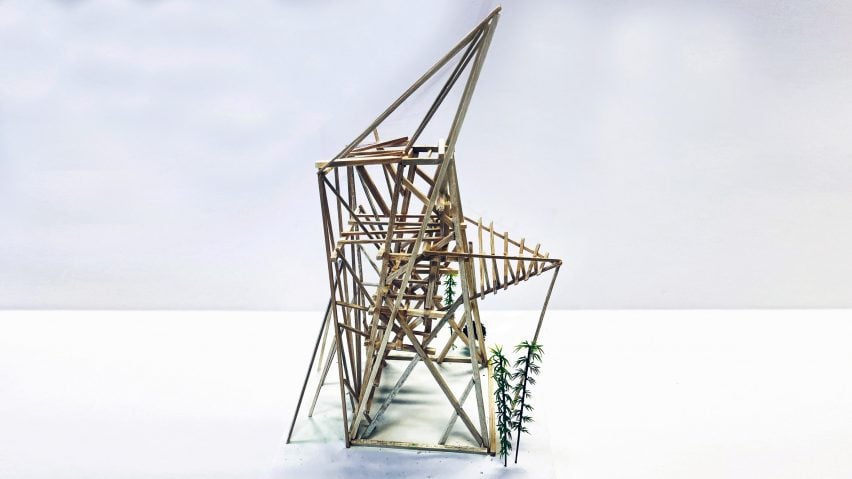 A photograph of an architectural model made from brown wooden sticks, in a geometric shape, against a white backdrop.