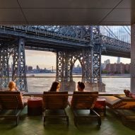 People sitting in chairs overlooking the water