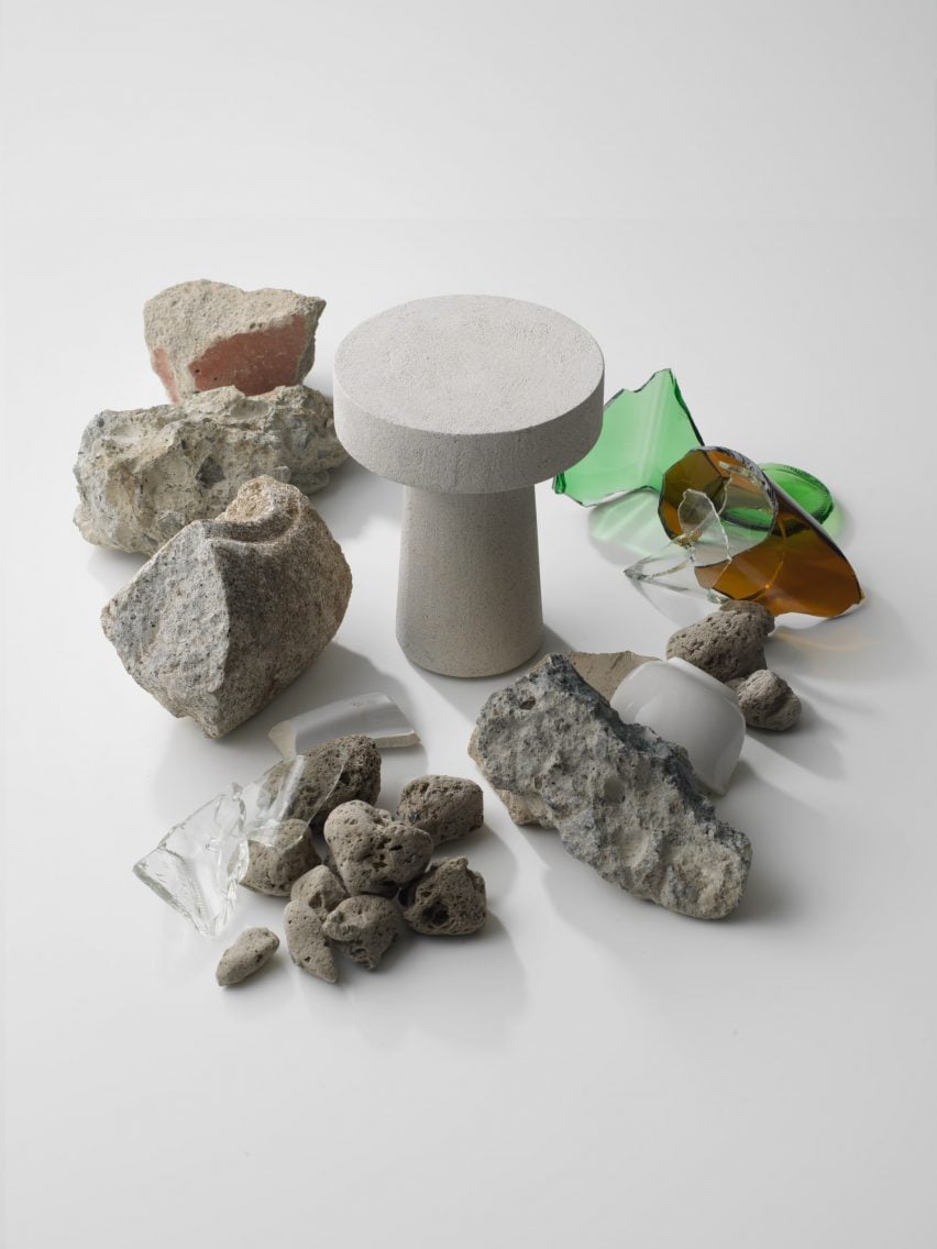 Remli light surrounded by pieces of glass, concrete and ceramics