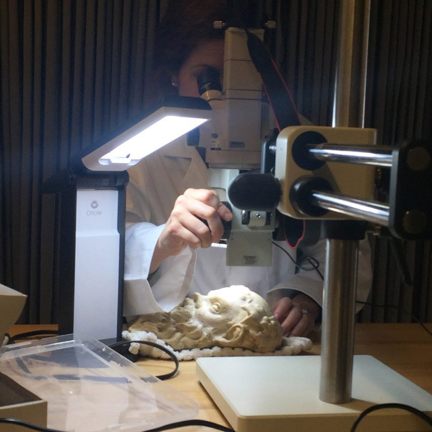 a photograph of a person using a telescope