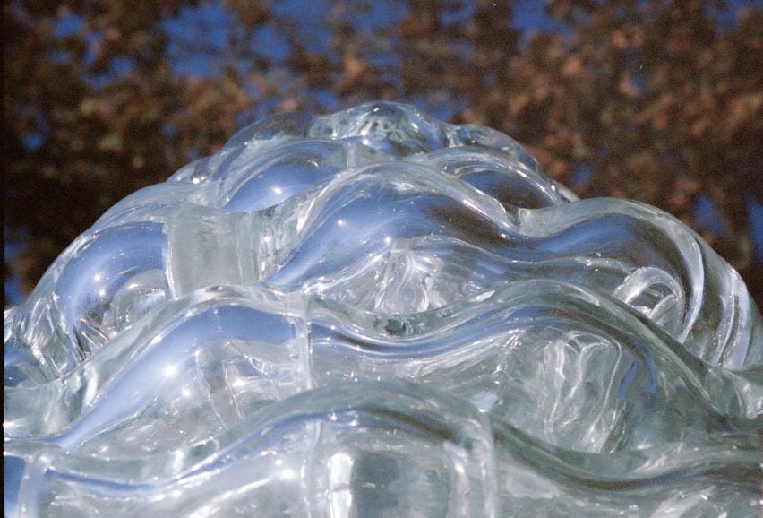 Close-up photo of the doubly curved glass bricks of the Serpentine Bell sculpture slotted into each other