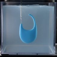 A photograph of a blue Coperni bag being rapid liquid 3D-printed