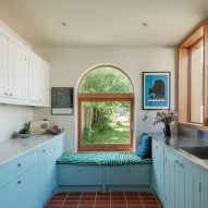 Tiled floor and blue wood panelling in kitchen extension