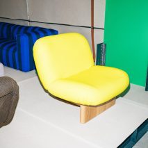 Yellow chair on white plinth