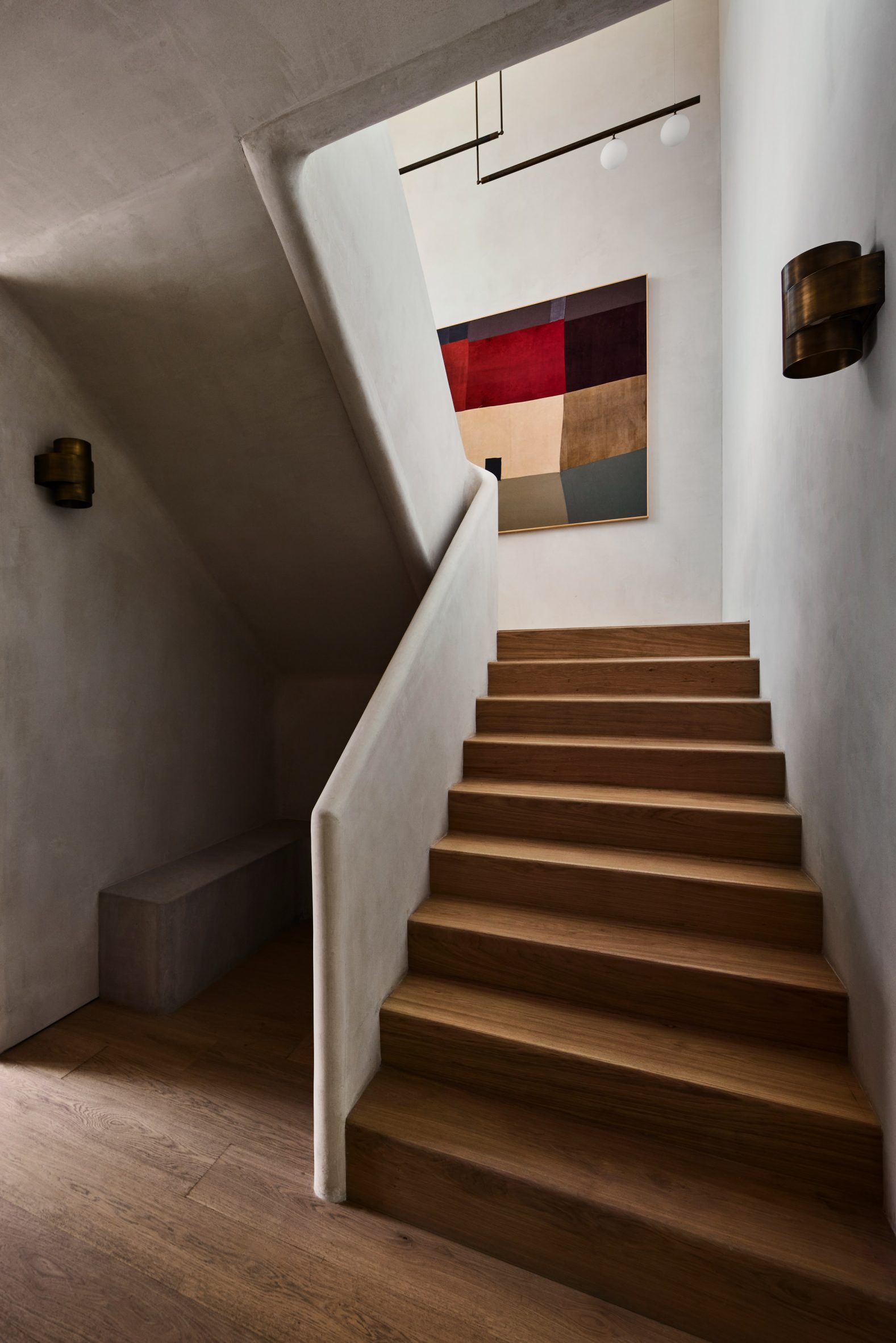 Plaster staircase featuring a solid banister with softly curved edges