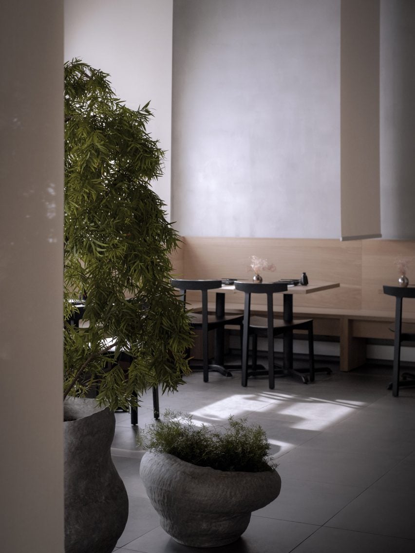 Plants in front of a minimalist restaurant interior