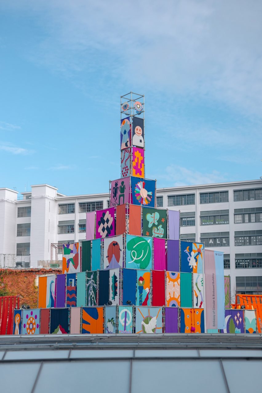 Scaffolding pyramid clad in colourful flags