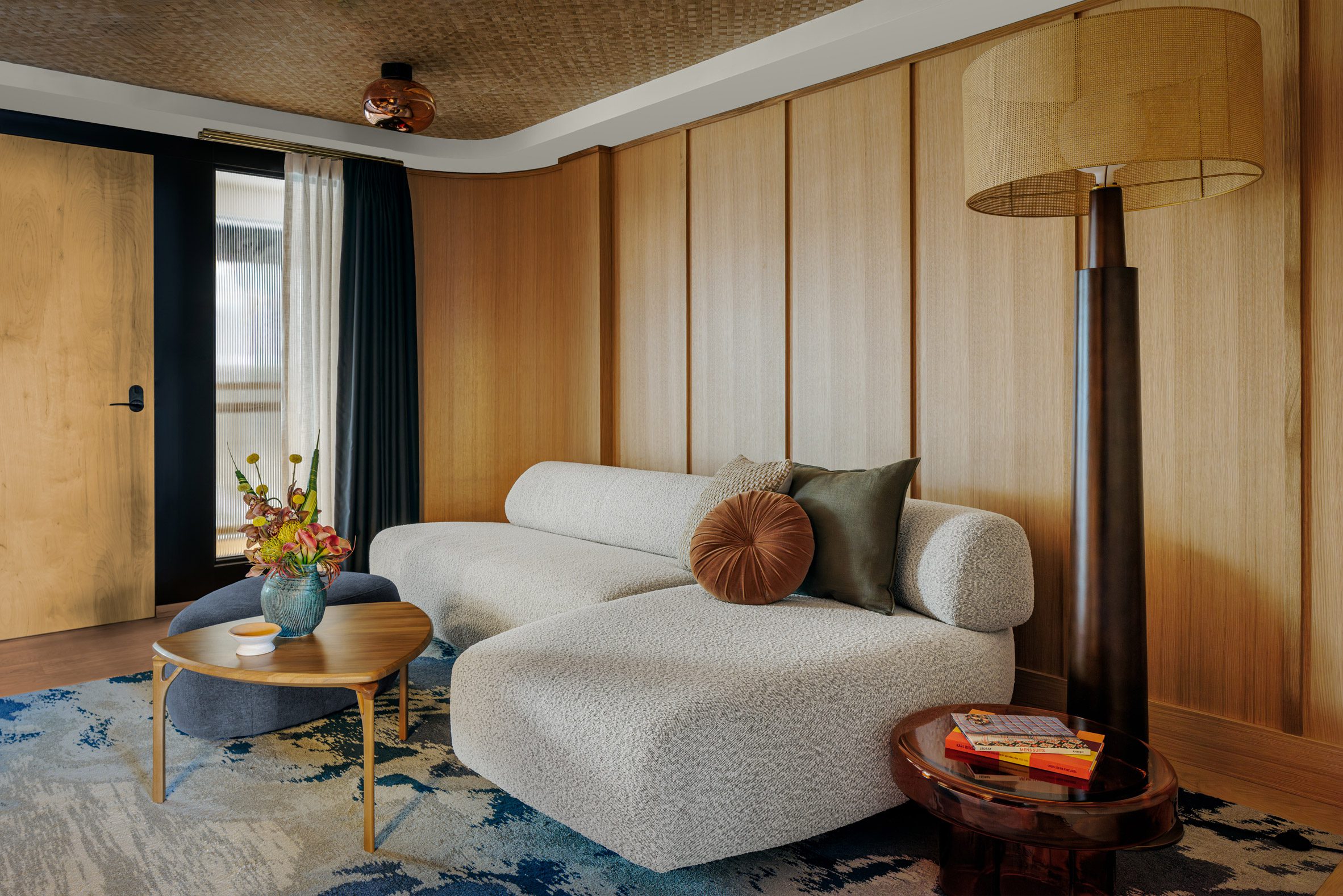 Suite featurung wood-panelled walls and a woven ceiling