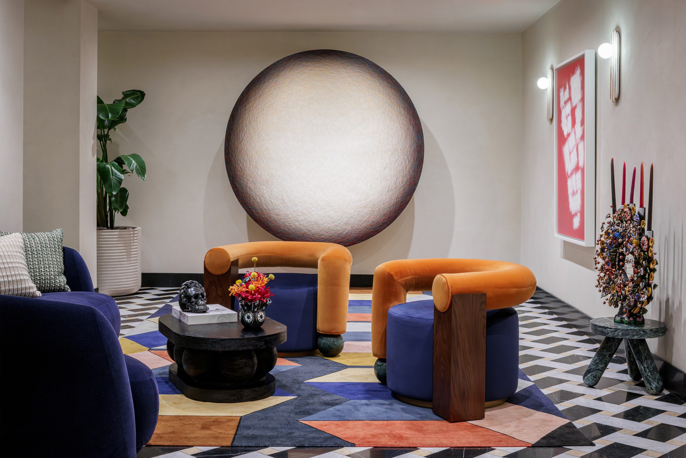 Lobby ioutfitted with black and white flooring, and contrasting colourful furniture