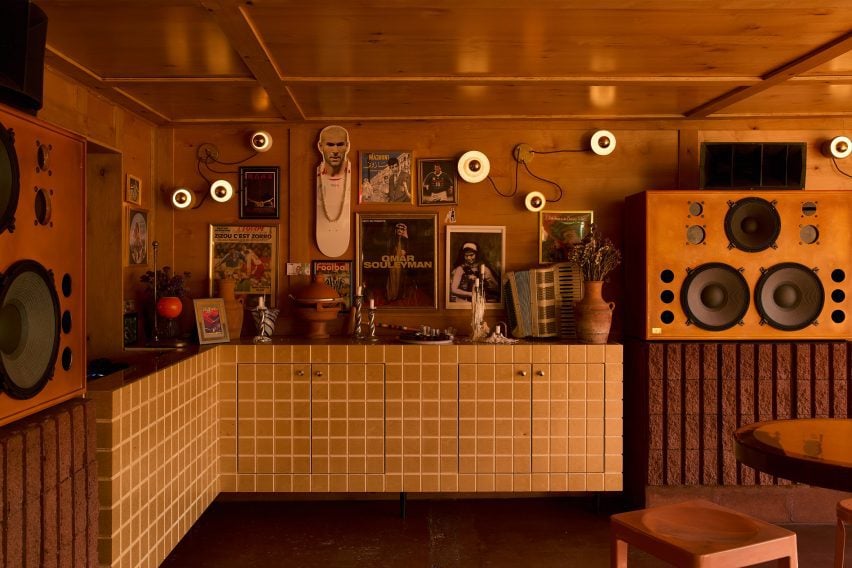 Tiled cabinets, wooden speakers and various decor pieces in a restaurant