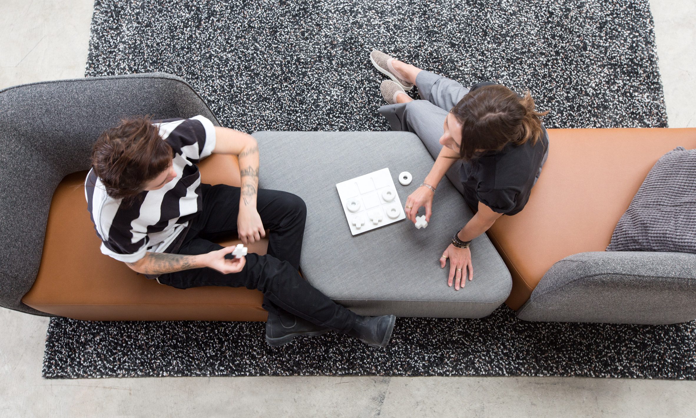 Aerial photo of two people sitting and working facing each other on the Peak lounge seating