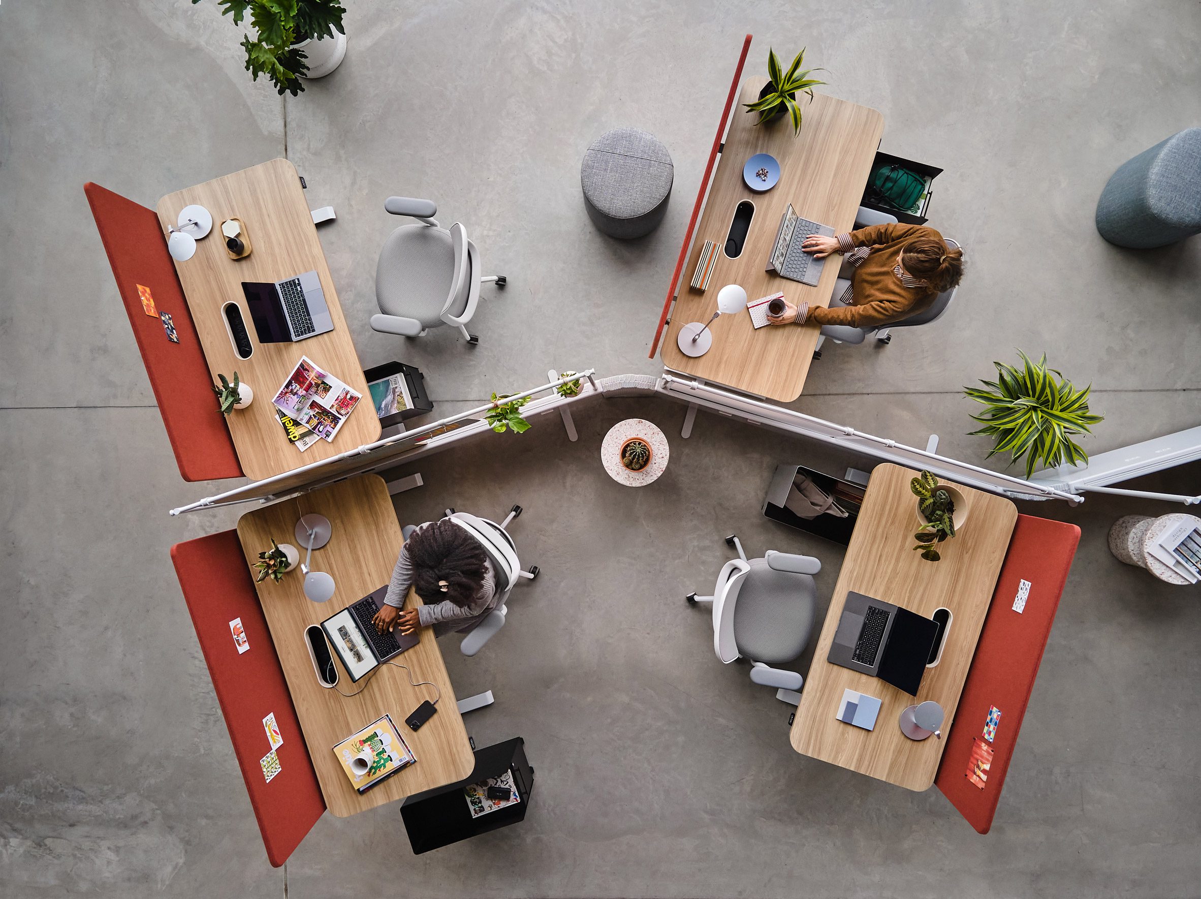 Aerial photo of people at individual workstations within an open office