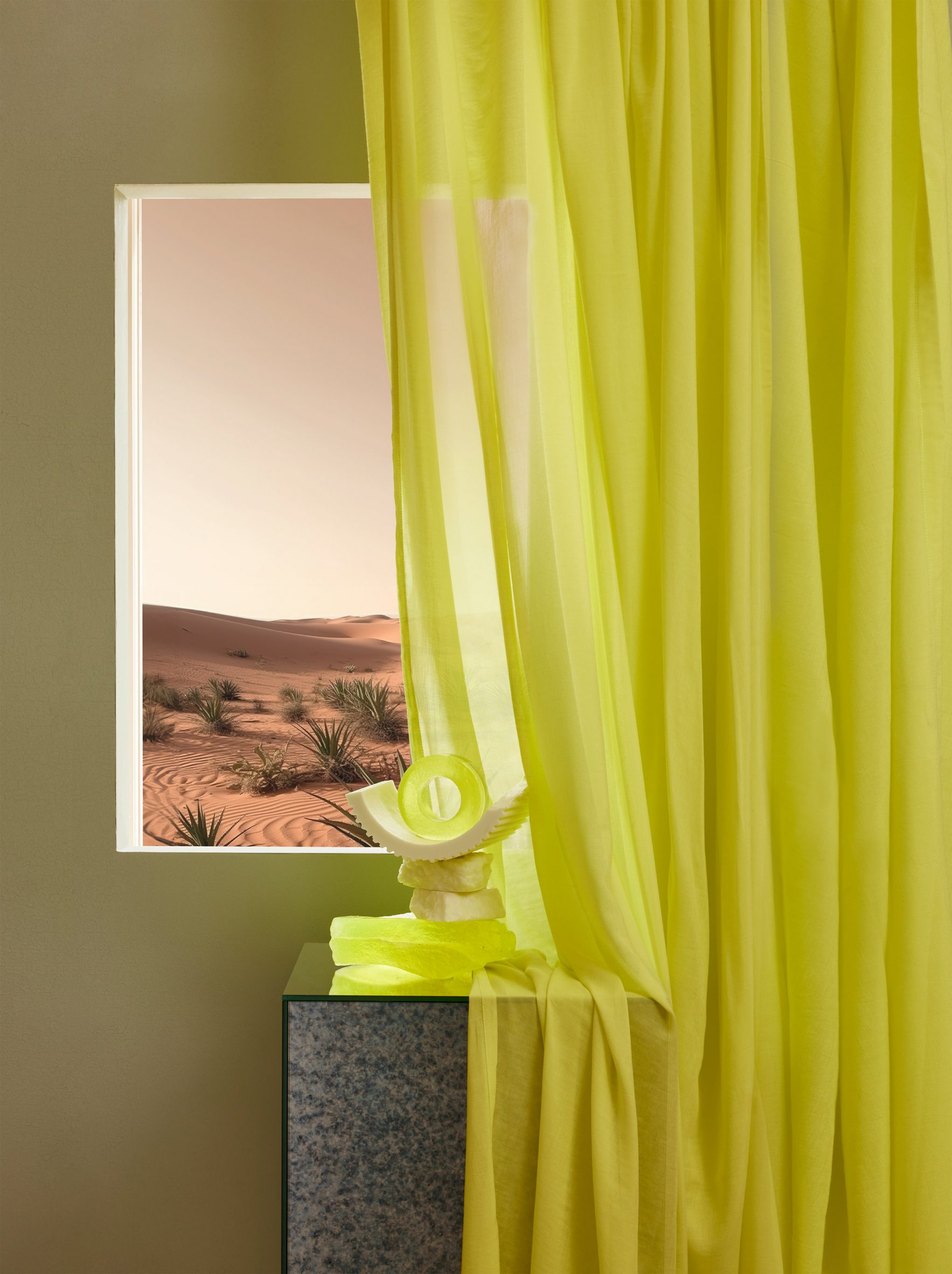 Photo of a curtain in Kirkby Design's Aloe vera fabric in a bold acid yellow colour hanging partially in front of an artwork that is partially covered