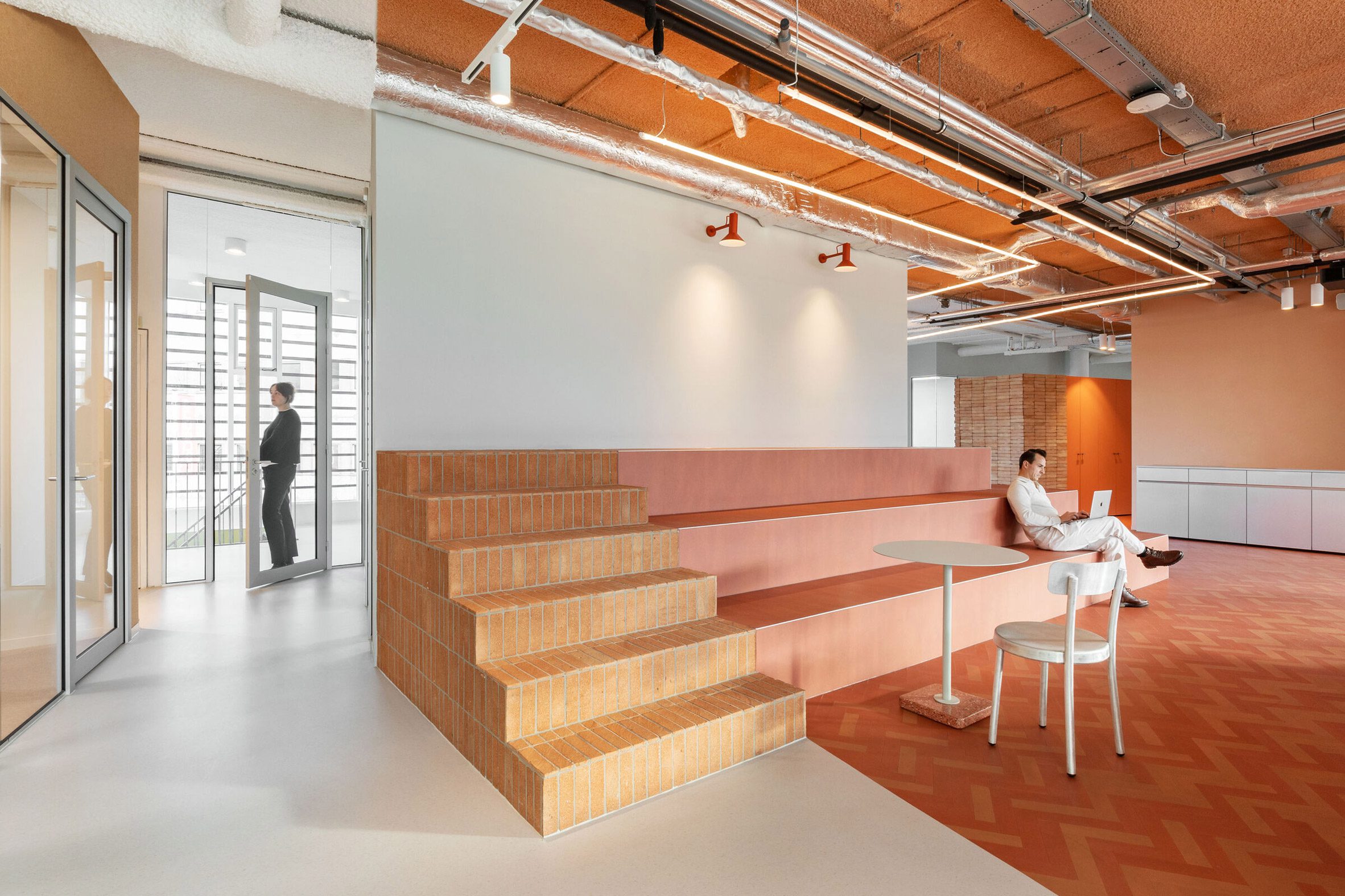 Seating area inside workspace by Firm Architects 