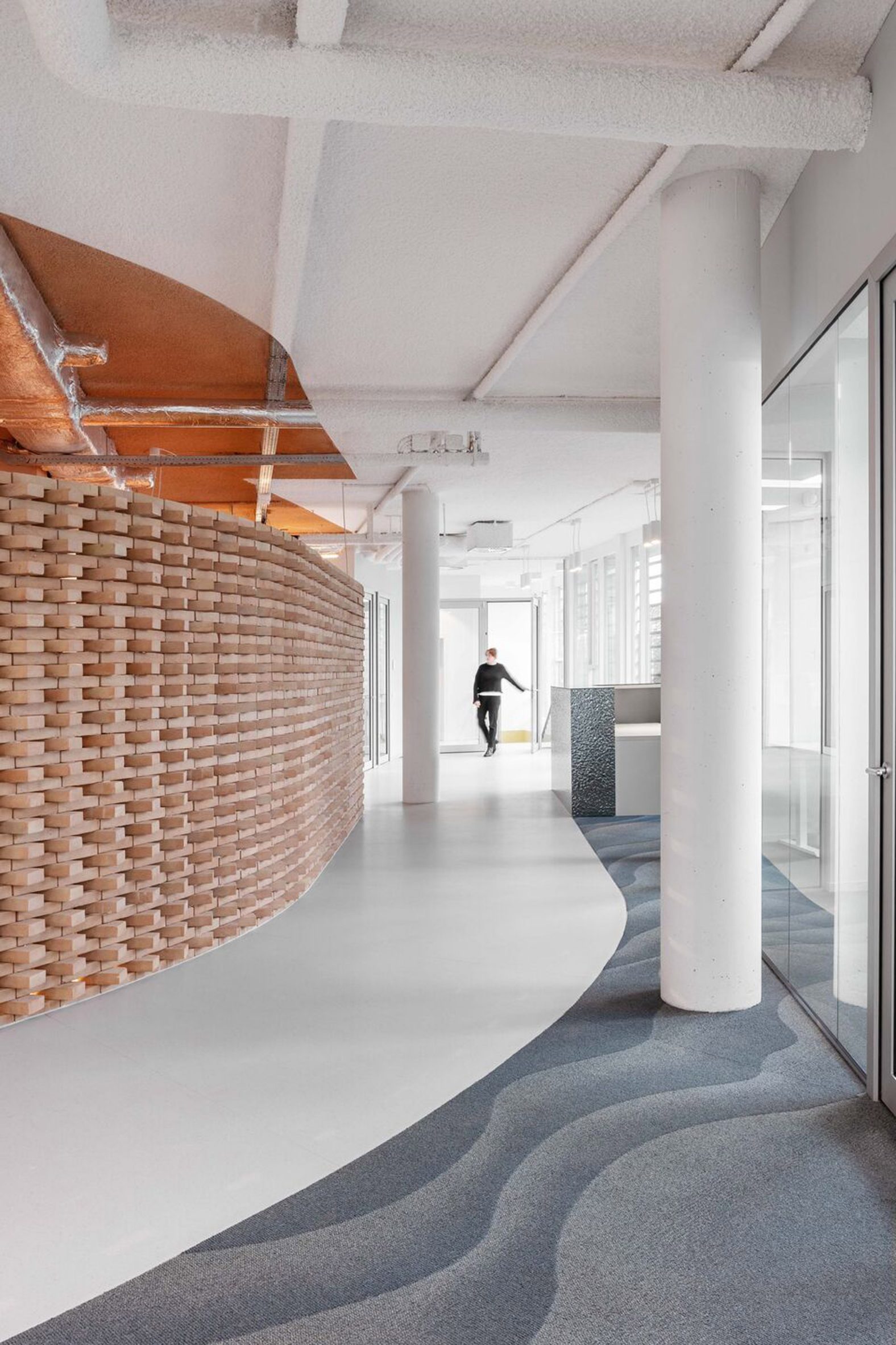 Curved brick wall in Land over water office by Firm Architects 