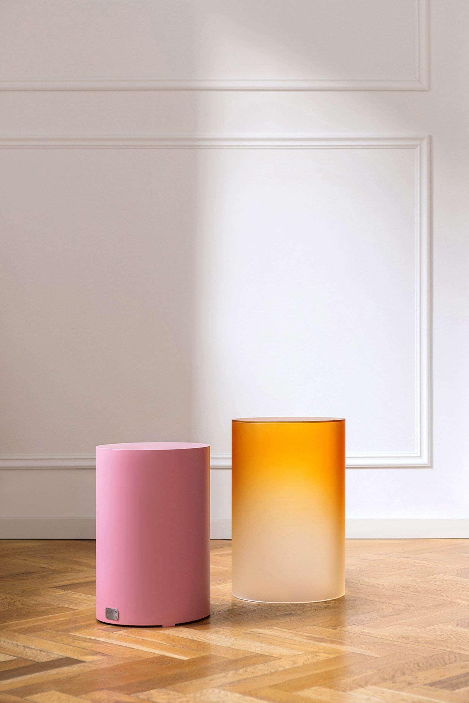 Ombre glass cylinder next to pink metal cylinder