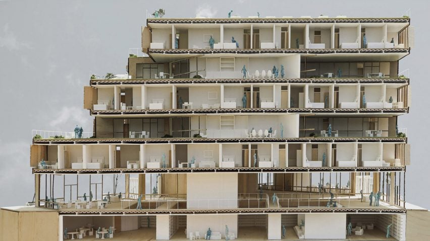 A photograph of an architectural model in tones of brown and white, with small figurines throughout.